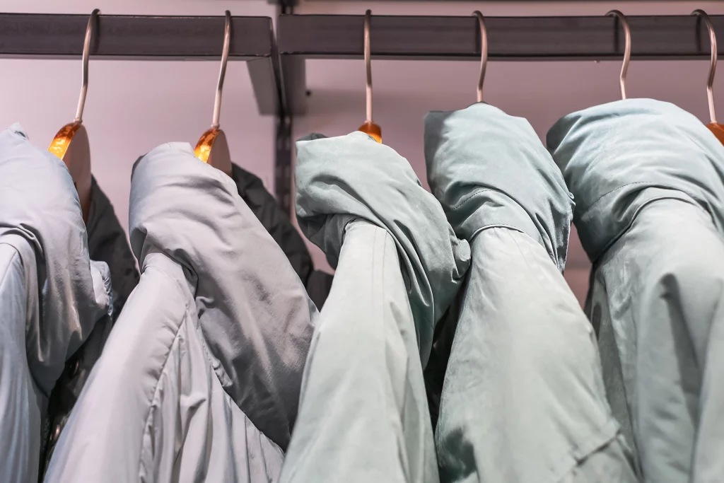 blue winter down jackets hanging on hangers in the 2023 11 27 05 35 21 utc